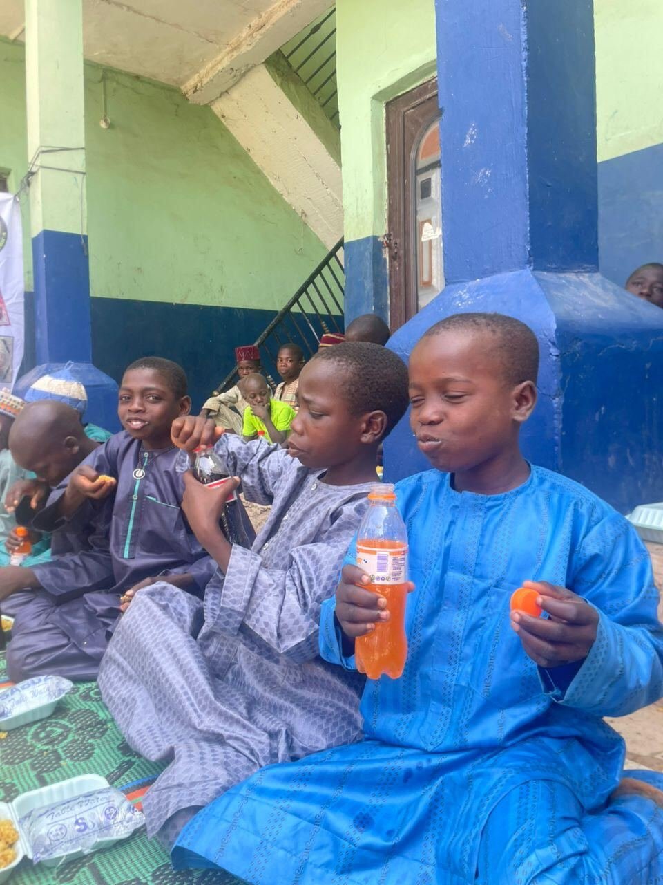 Boys enjoying a meal and a drink
