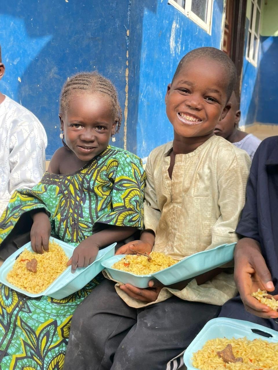 Two friends smiling over their meal