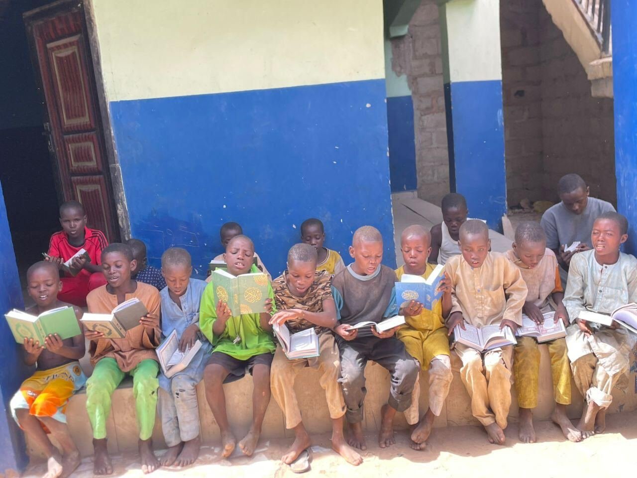 Children sitting together reading their books