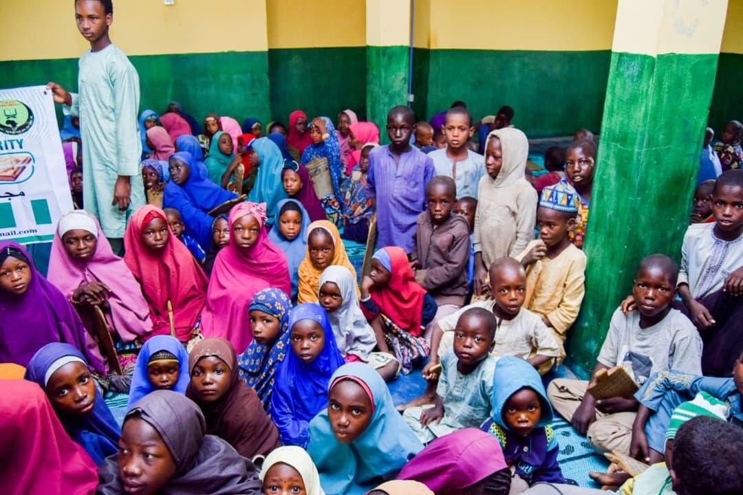 Girls gathered in a hall waiting for Qurans