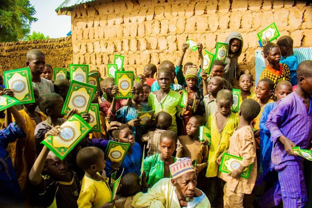Children holding up their new Qurans