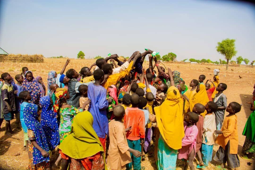 Children cheering outside after a Quran distribution