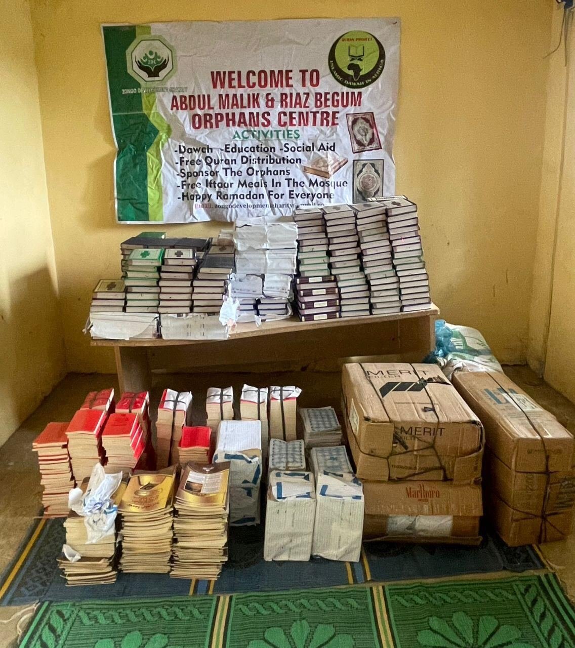 Qurans stacked under the welcome banner